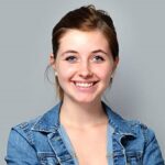 smiling teenage girl standing with crossed arms